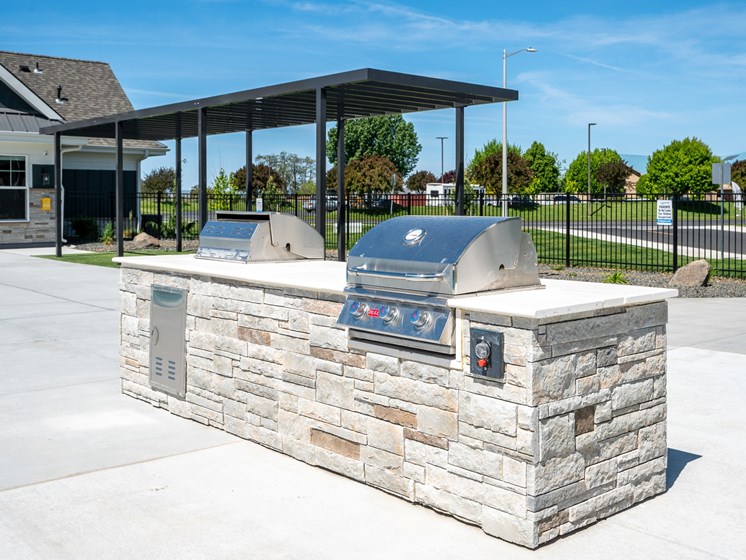 outdoor grill and cooking area next to pool